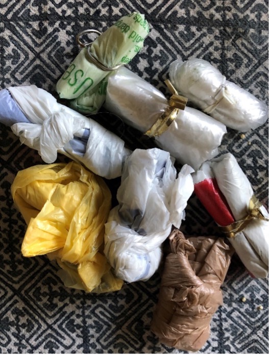 Eight plastic bags of different colors and types, all bundled up